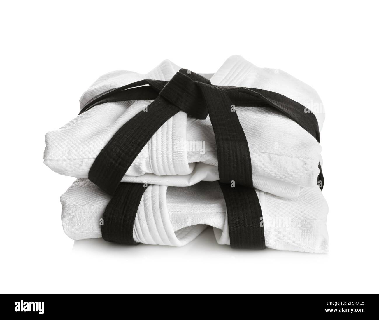 Martial arts uniform with black belts on white background Stock Photo