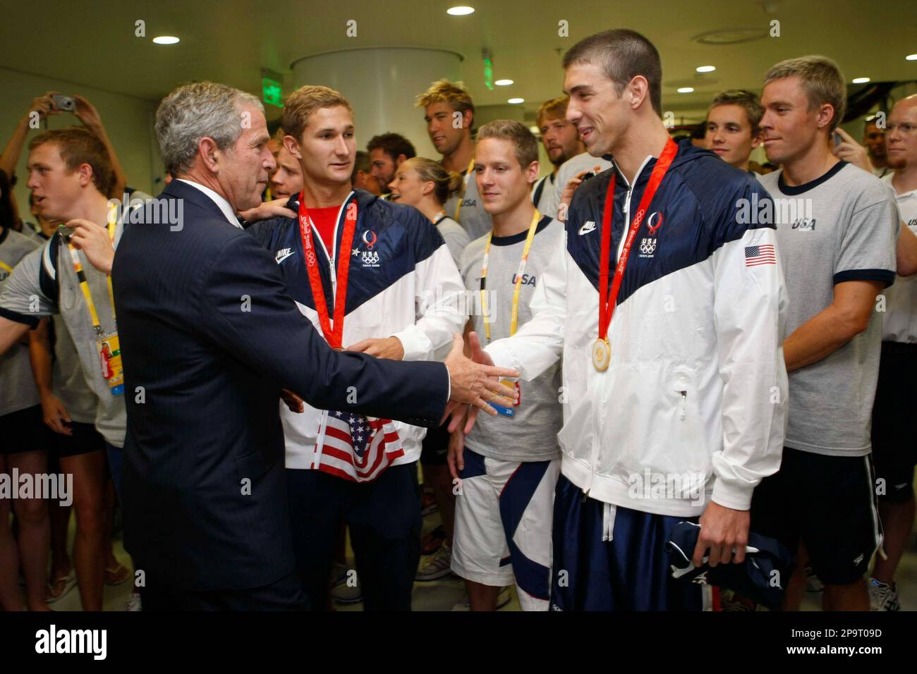President Bush greets gold medal and world record winner Michael Phelps