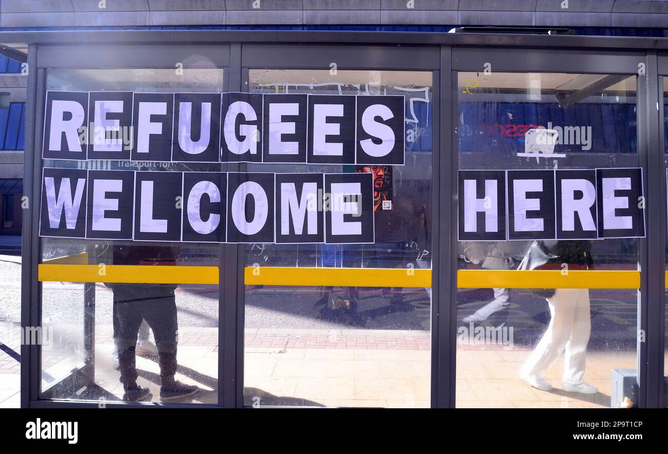 'Refugees welcome here' sign, flyposted on a bus shelter in Manchester, UK. This is in reaction to the UK government's controversial plan aimed at blocking undocumented migrants from entering the country on small boats. Stock Photo