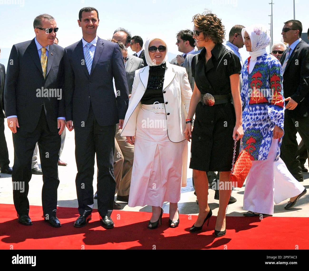 Syrian President Bashar Assad, second left, and his wife Asma Assad ...