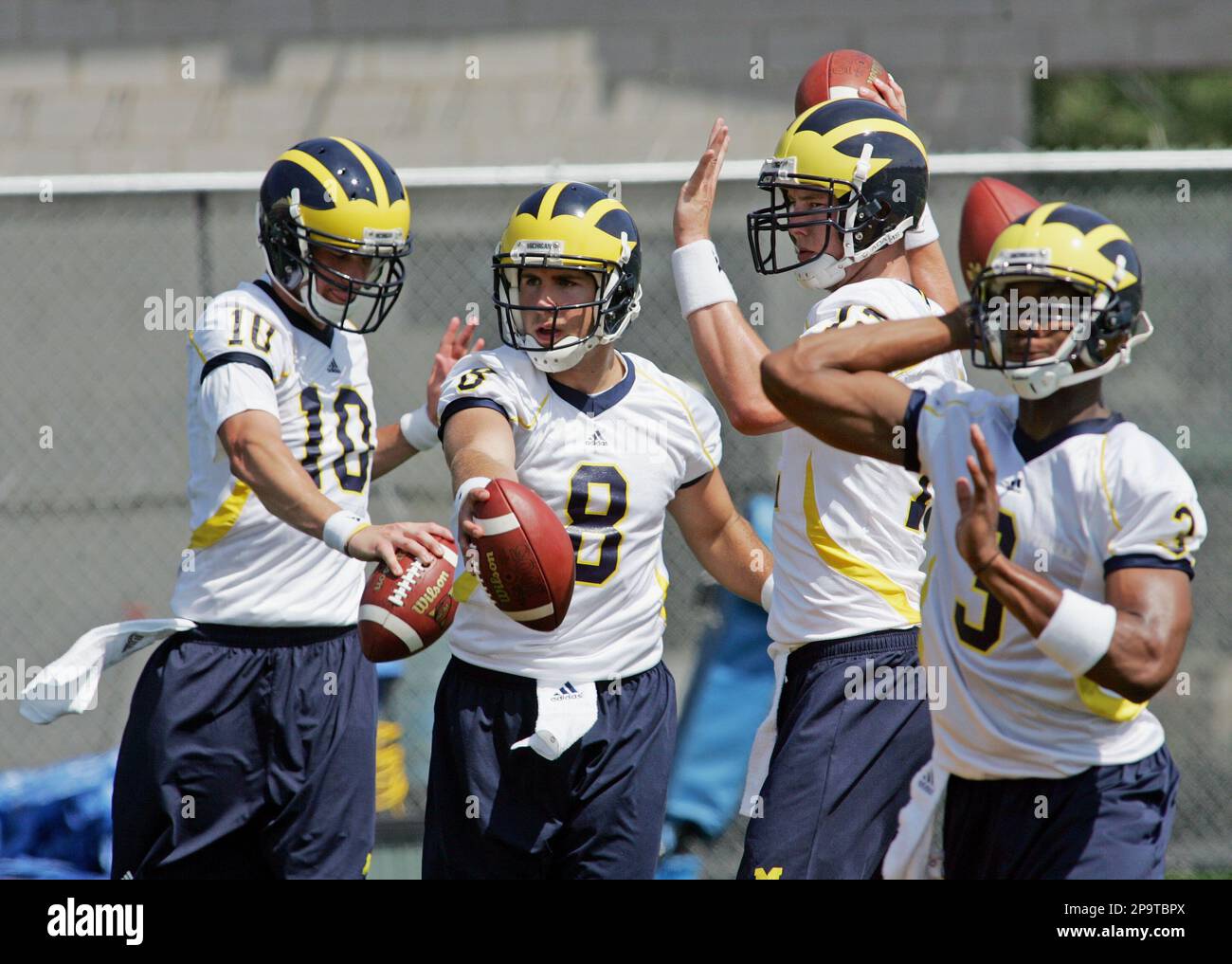 Michigan quarterbacks Steven Threet, Nick Sheridan, David Cone, and  freshman Justin Feagin, from left, run through a passing drill on the first  day of their football practice for the season Monday, Aug.