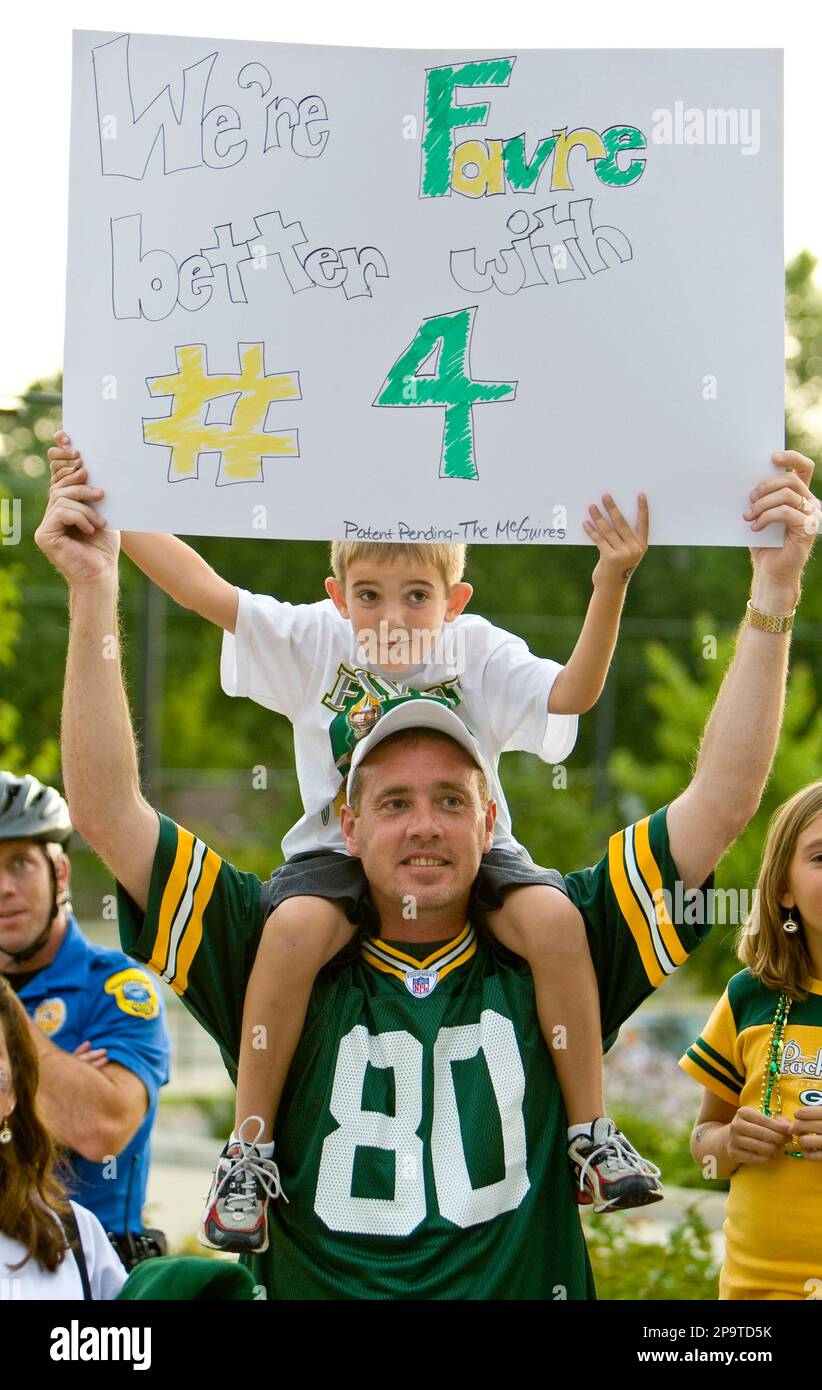 ASHWAUBENON, WI - JULY 27: Green Bay Packers linebacker Isaiah McDuffie  (58) bikes with a fan during Green Bay Packers training camp at Ray  Nitschke Field on July 27, 2022 in Ashwaubanon