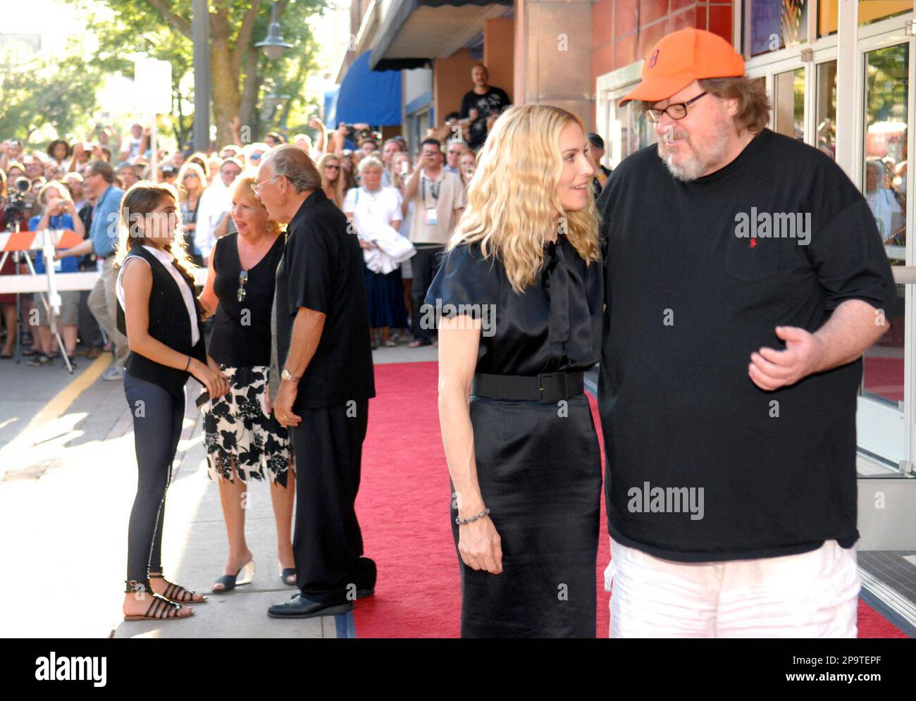 Madonna talks with filmmaker Michael Moore, right, as her daughter Lourdes  Leon, 11, left, talks with Madonna's father and step-mother, Joan and Tony  Ciccone, at the screening of her documentary film \, image size:1300x995