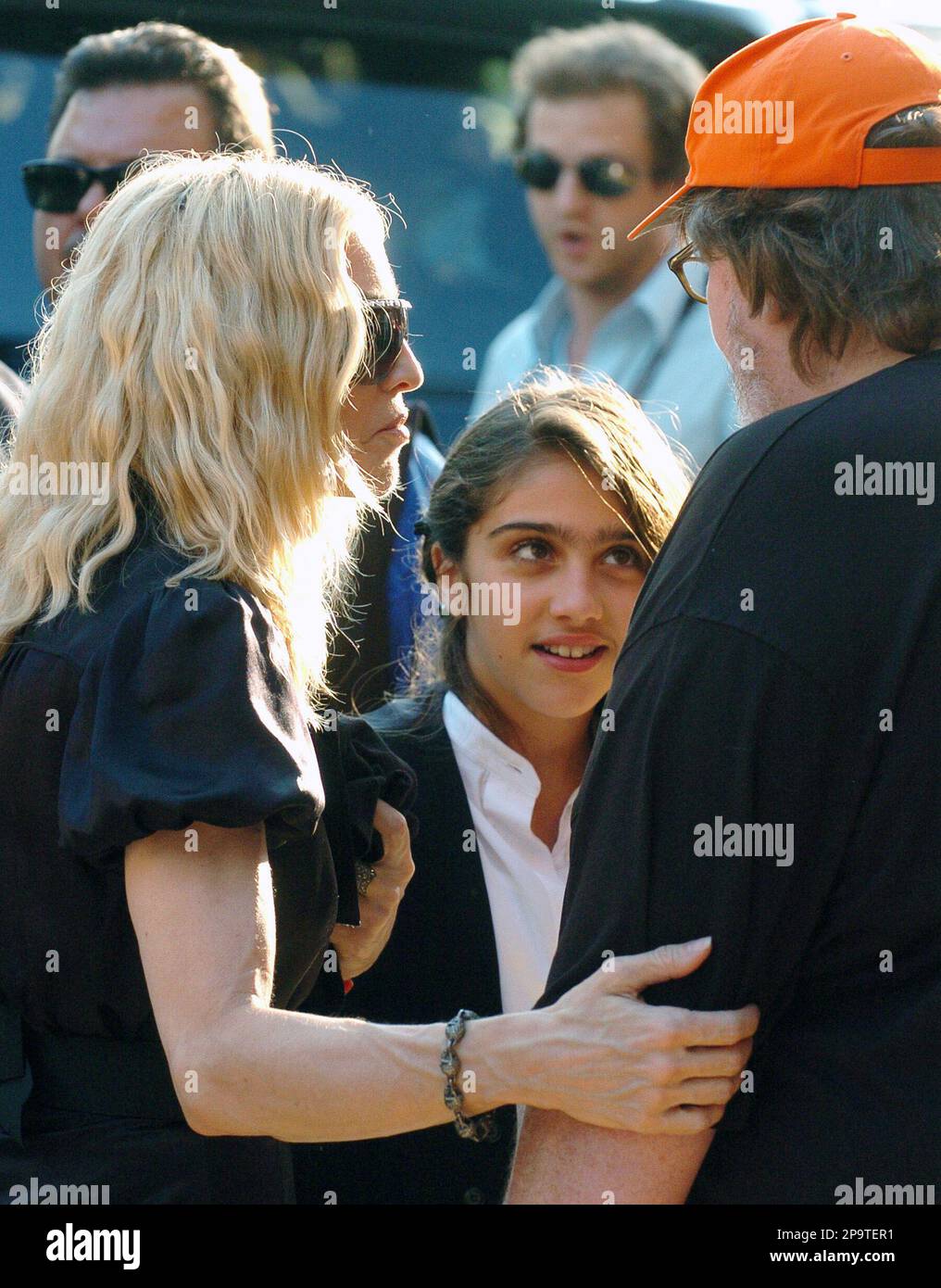 Madonna, left, introduces her daughter Lourdes Leon, 11, center, to  filmmaker Michael Moore, right, at the screening of her documentary film \, image size:1016x1390