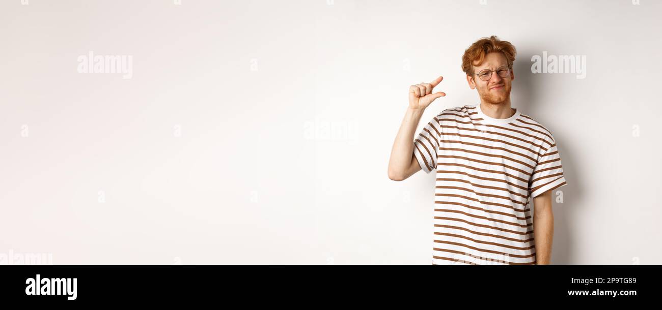 Man Small Resolution Disappointed young man with red hair and beard, wearing glasses and ...