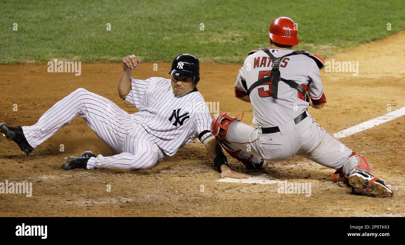 New York Yankees' Ivan Rodriguez slides into home plate as Los Angeles  Angels catcher Jeff Mathis turns to put the tag on during the seventh  inning of a baseball game Thursday, July