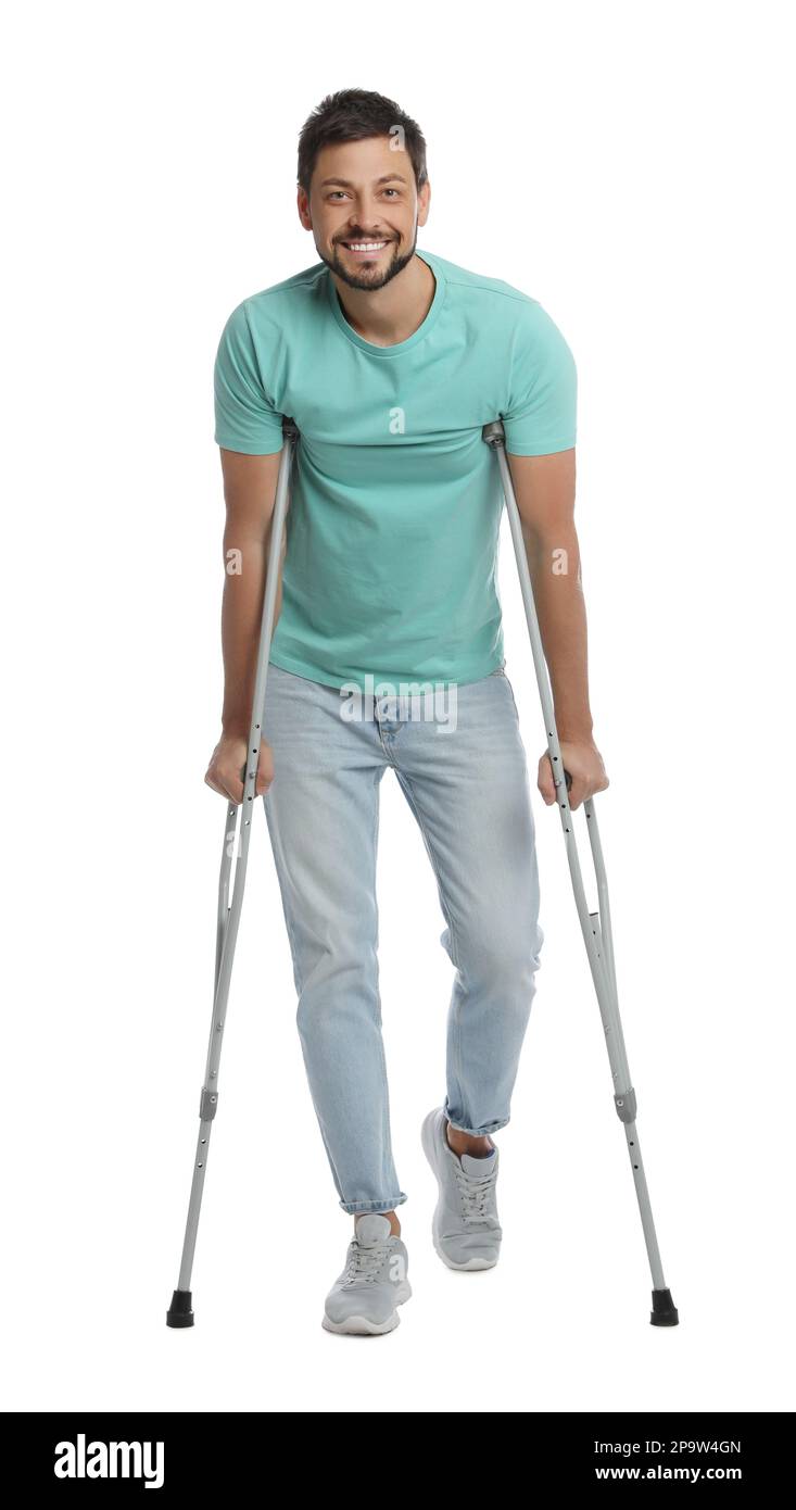 Full length portrait of man with crutches on white background Stock
