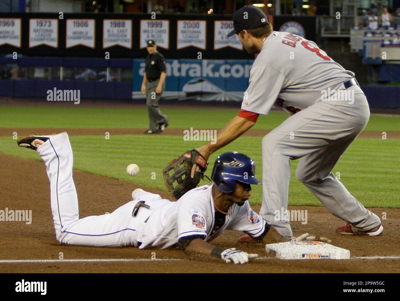 New York Mets' Jose Reyes, bottom, slides safely into third base ahead ...