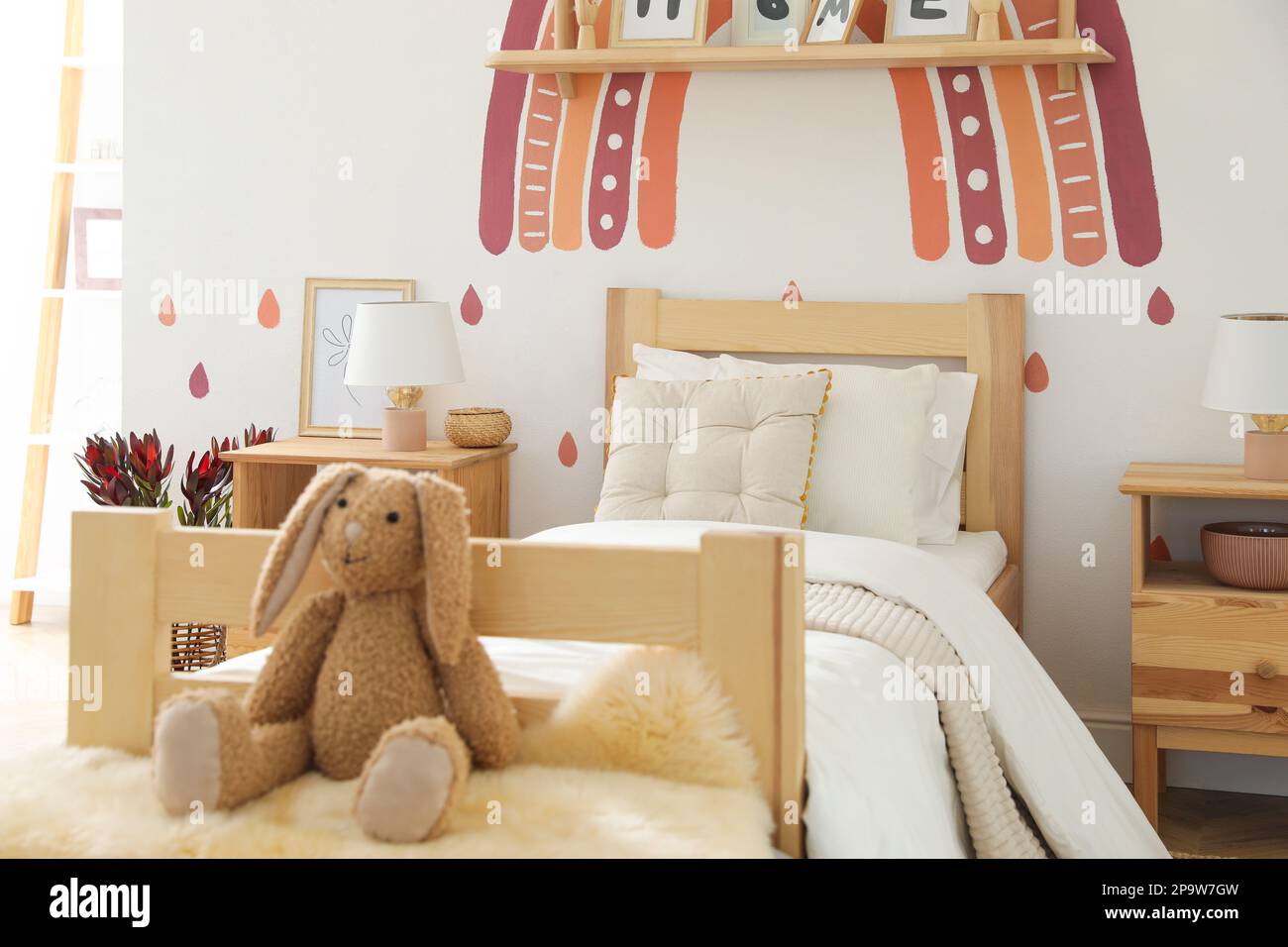 Toy bunny on faux fur in modern girl's bedroom. Interior design Stock ...