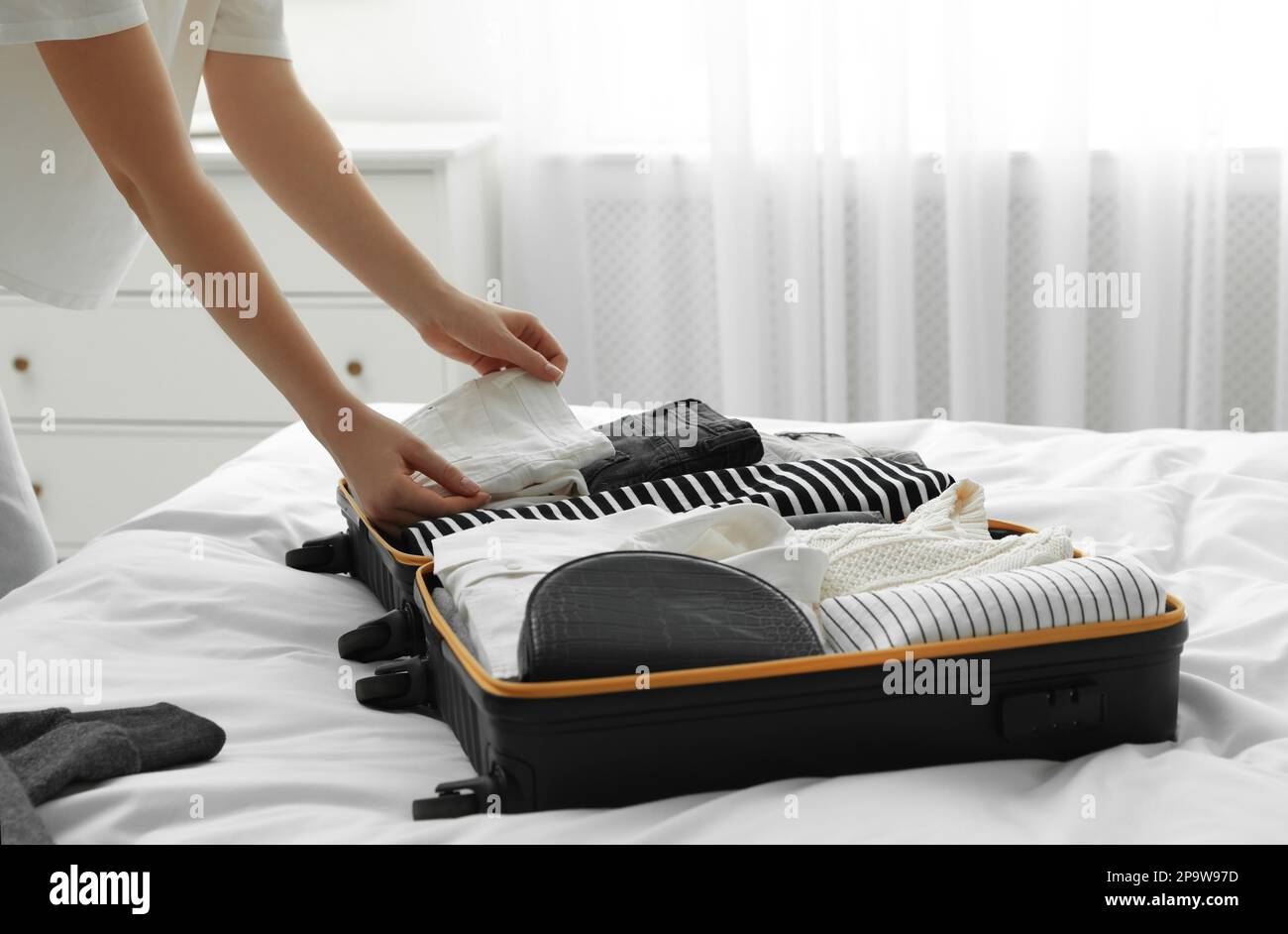 Black woman packing suitcase hi-res stock photography and images - Alamy