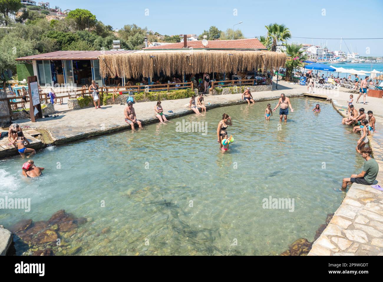 Datca, Mugla, Turkey – August 19, 2022. Ilica-Kargi geothermal bath in Datca resort town of Mugla, Turkey. View of the hot springs with people. Stock Photo
