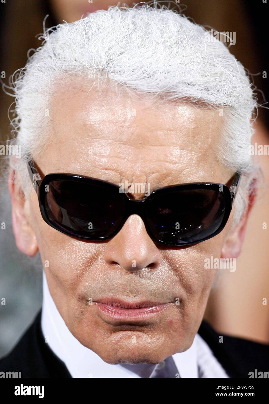 German fashion designer Karl Lagerfeld looks on after he received the