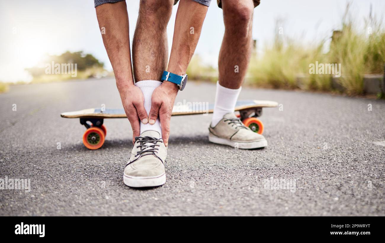 Ankle pain, injury and skater with ache or hurt foot while skating on the  road or street as extreme sport. Exercise, fitness and skateboarder with  Stock Photo - Alamy