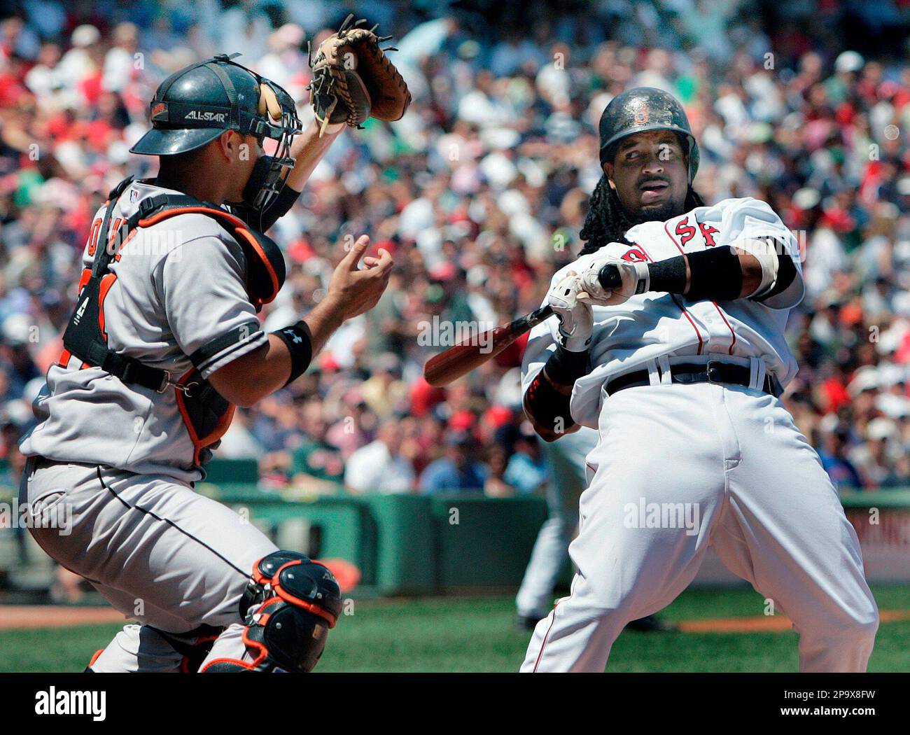 Boston Red Sox's Manny Ramirez, right, dodges a high pitch as Baltimore