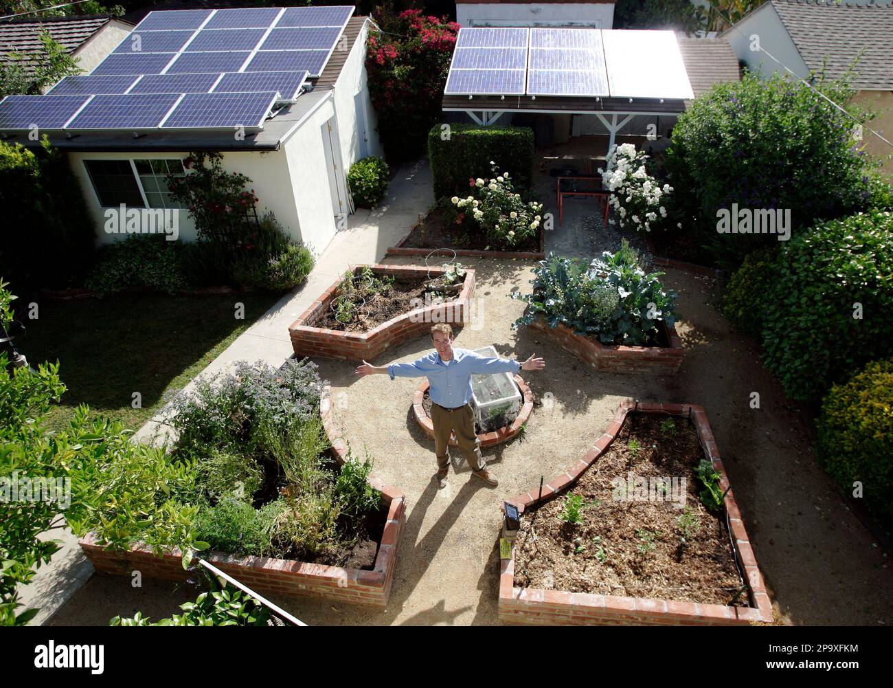 Bill Nye "The Science Guy" poses in his alledible plant garden, with