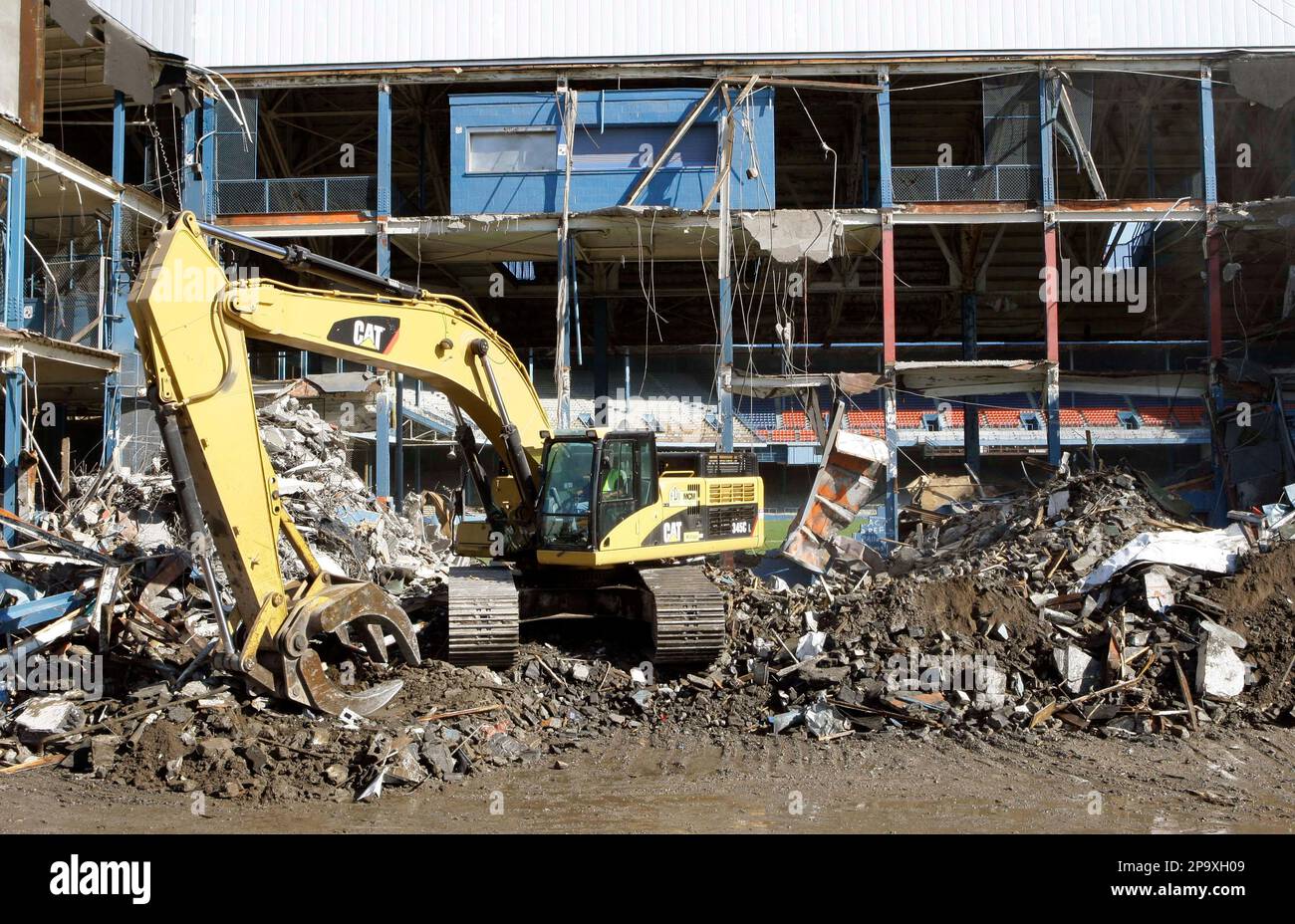 Demolition crews smash the walls of Tiger Stadium, punching