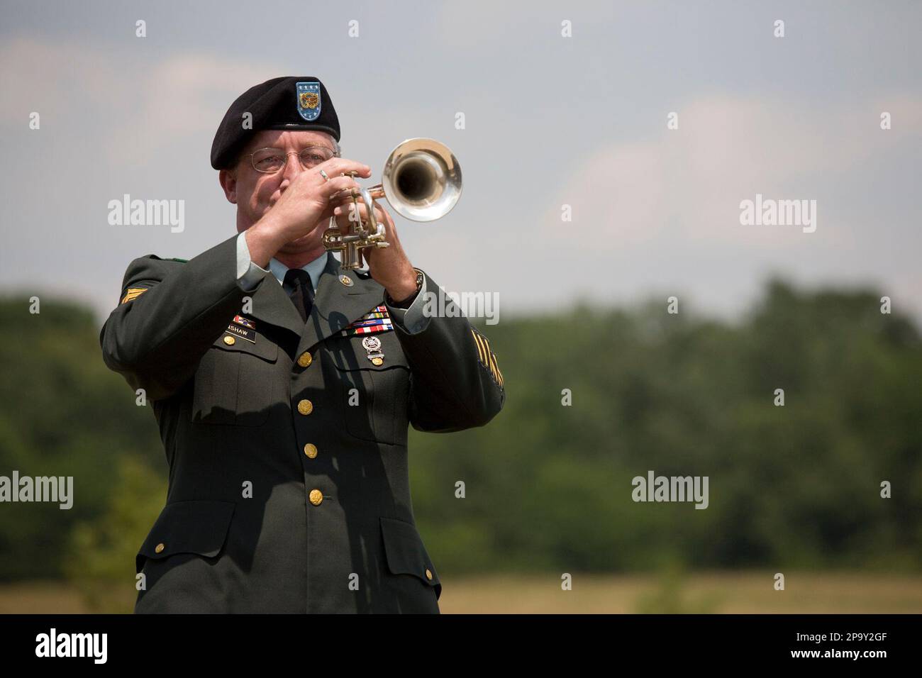Army First Sgt. Gregory Hanshaw plays "Taps" on the trumpet at the