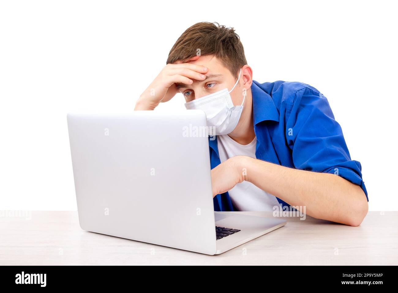 Sick Young Man in Flu Mask with Laptop Isolated on the White Background Stock Photo