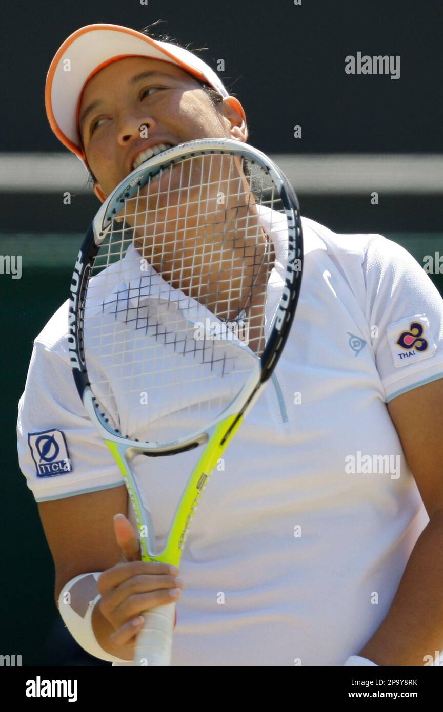 Thailand's Tamarine Tanasugarn bites her racquet, during her Women's Singles quarterfinal against Venus Williams of the US., on the Number One Court at Wimbledon, Tuesday, July 1, 2008. (AP Photo/Alastair Grant) Stock Photo