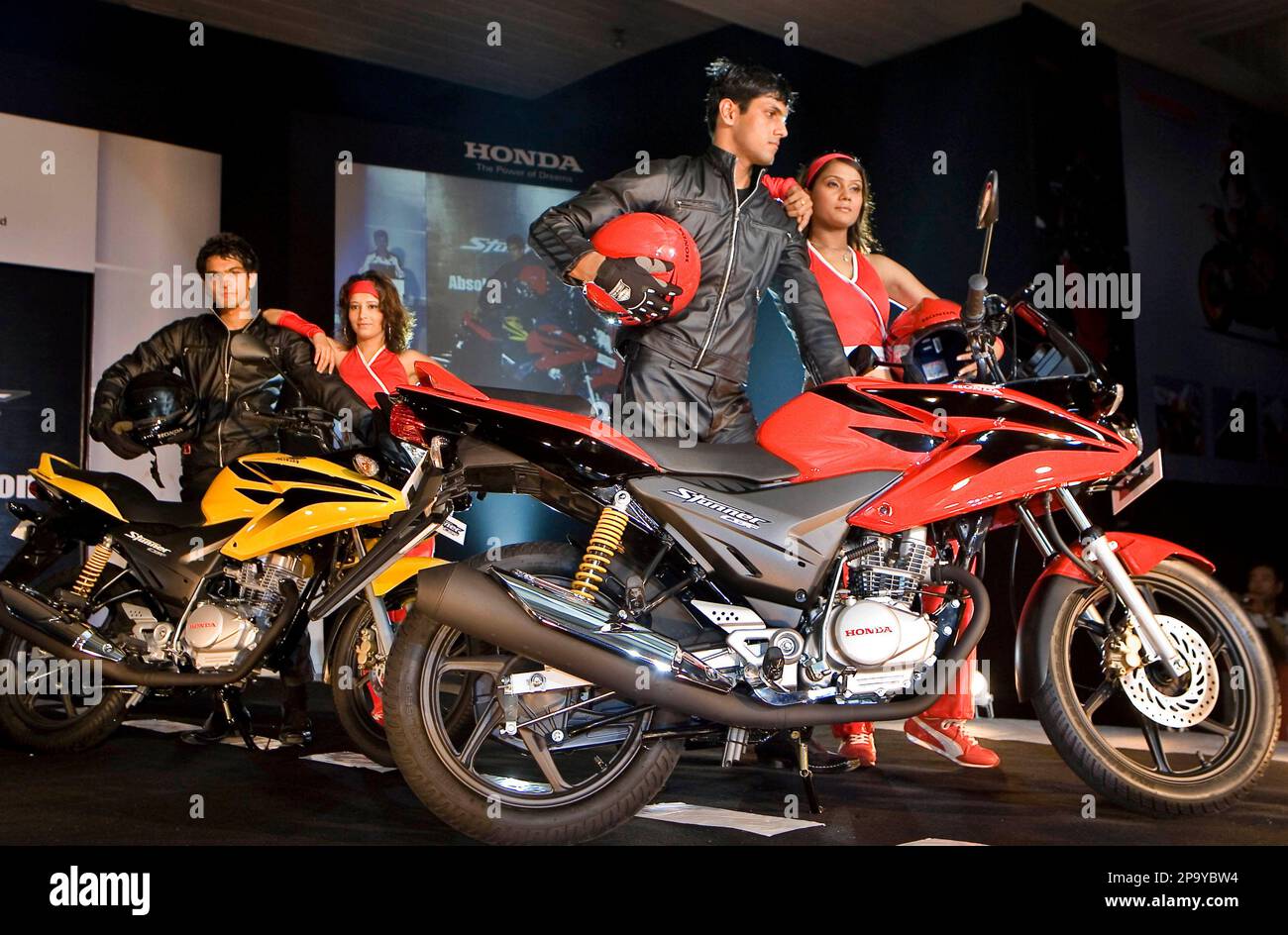 Models pose next to newly launched Honda CBF Stunner motorcycle at