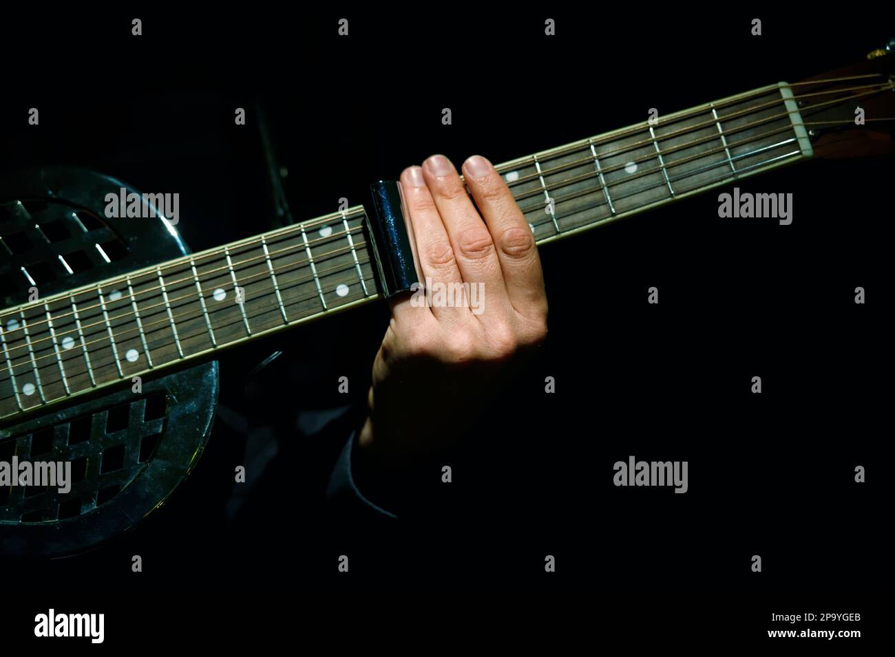 Playing resonator guitar with a slide Stock Photo Alamy