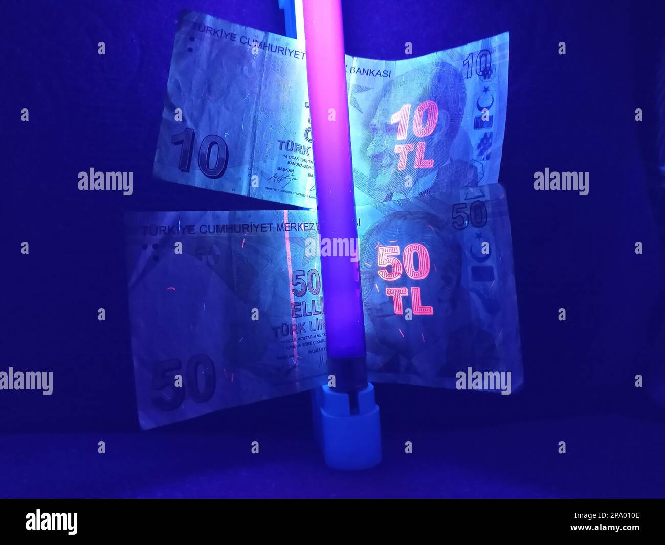 Ankara, Türkiye – February 23, 2023: Turkish lira banknotes under ultraviolet light Stock Photo