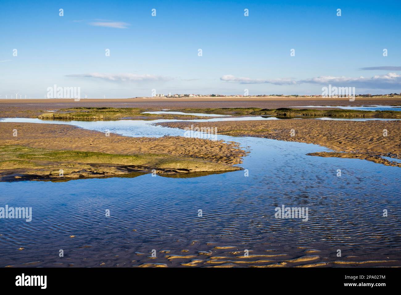 View to Hoylake across tidal pools from Little Hilbre island in Dee Estuary at low tide. West Kirby, Wirral Peninsula, Merseyside, England, UK Stock Photo