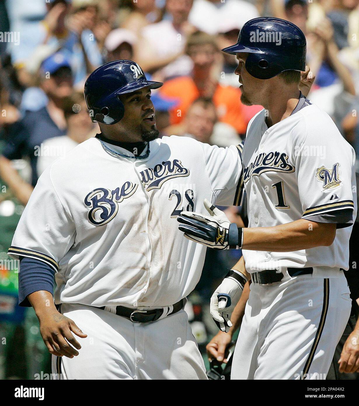 Milwaukee Brewers' Corey Hart (1) is congratulated by teammate Prince Fielder (28) after hitting