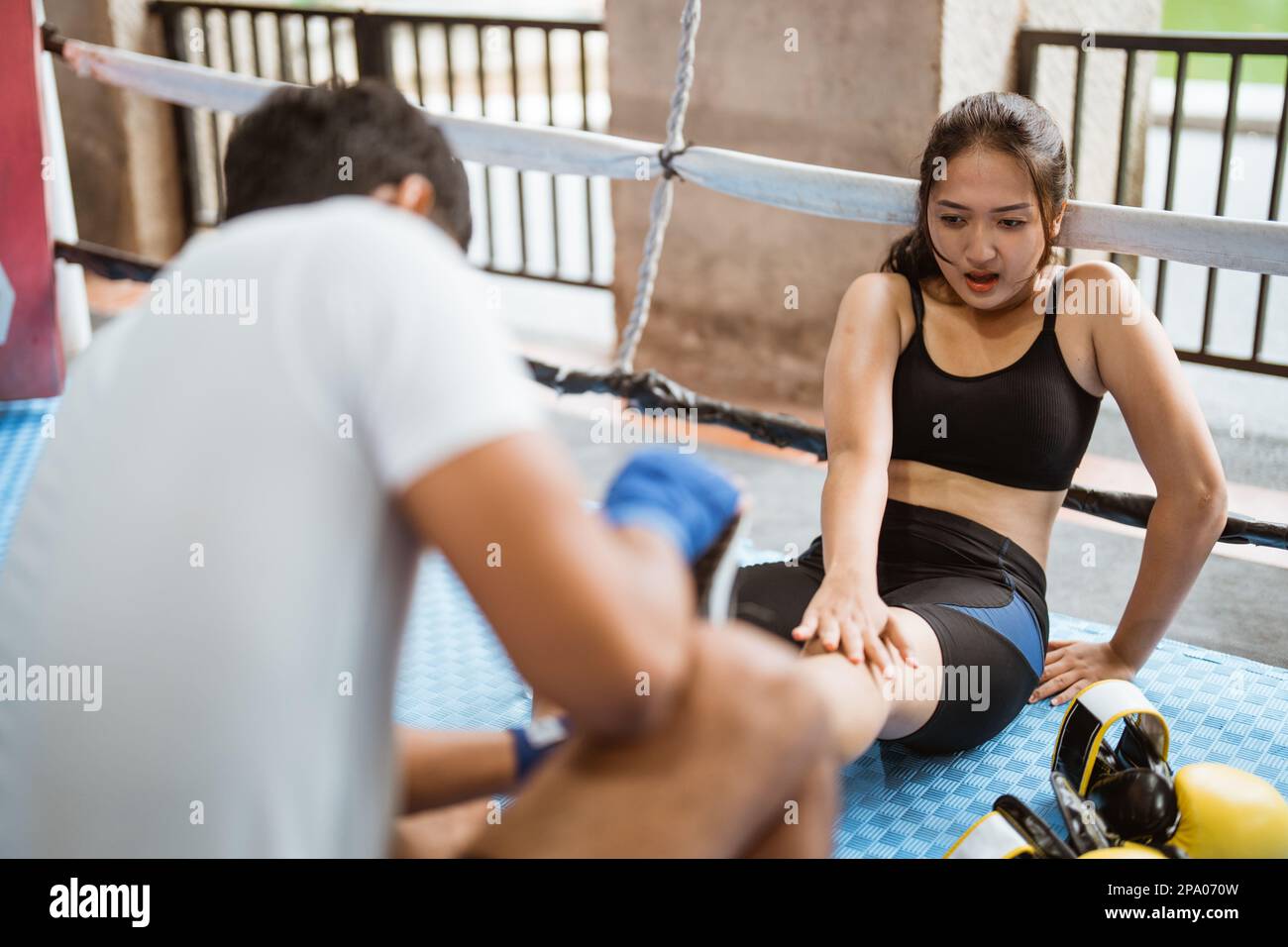 first aid from the boxing coach for the female boxer Stock Photo