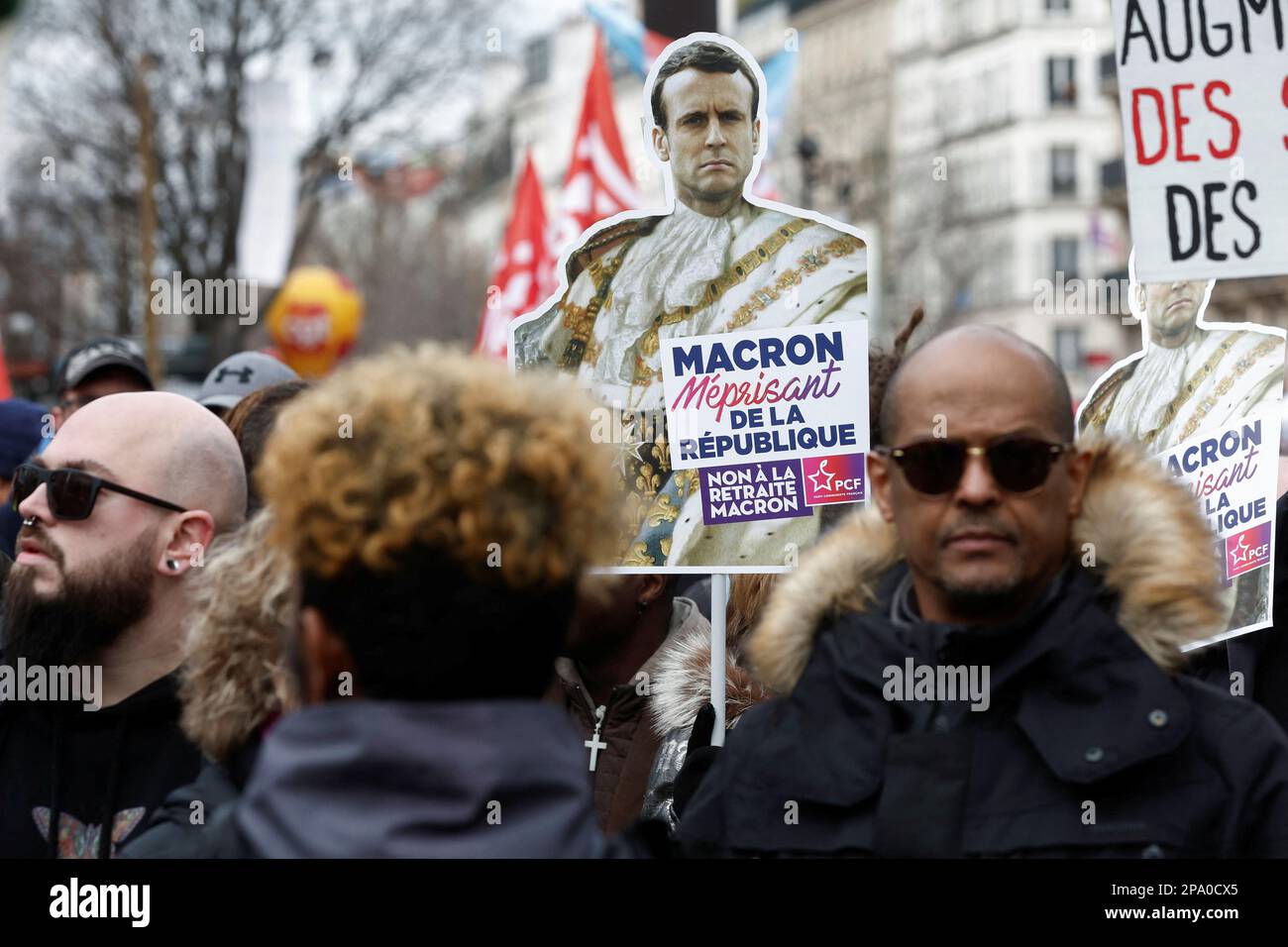 A demonstrator holds a sign with an image of French President Emmanuel Macron at a protest against the government's pension reform plan in Paris, France, March 11, 2023. REUTERS/Benoit Tessier Stock Photo