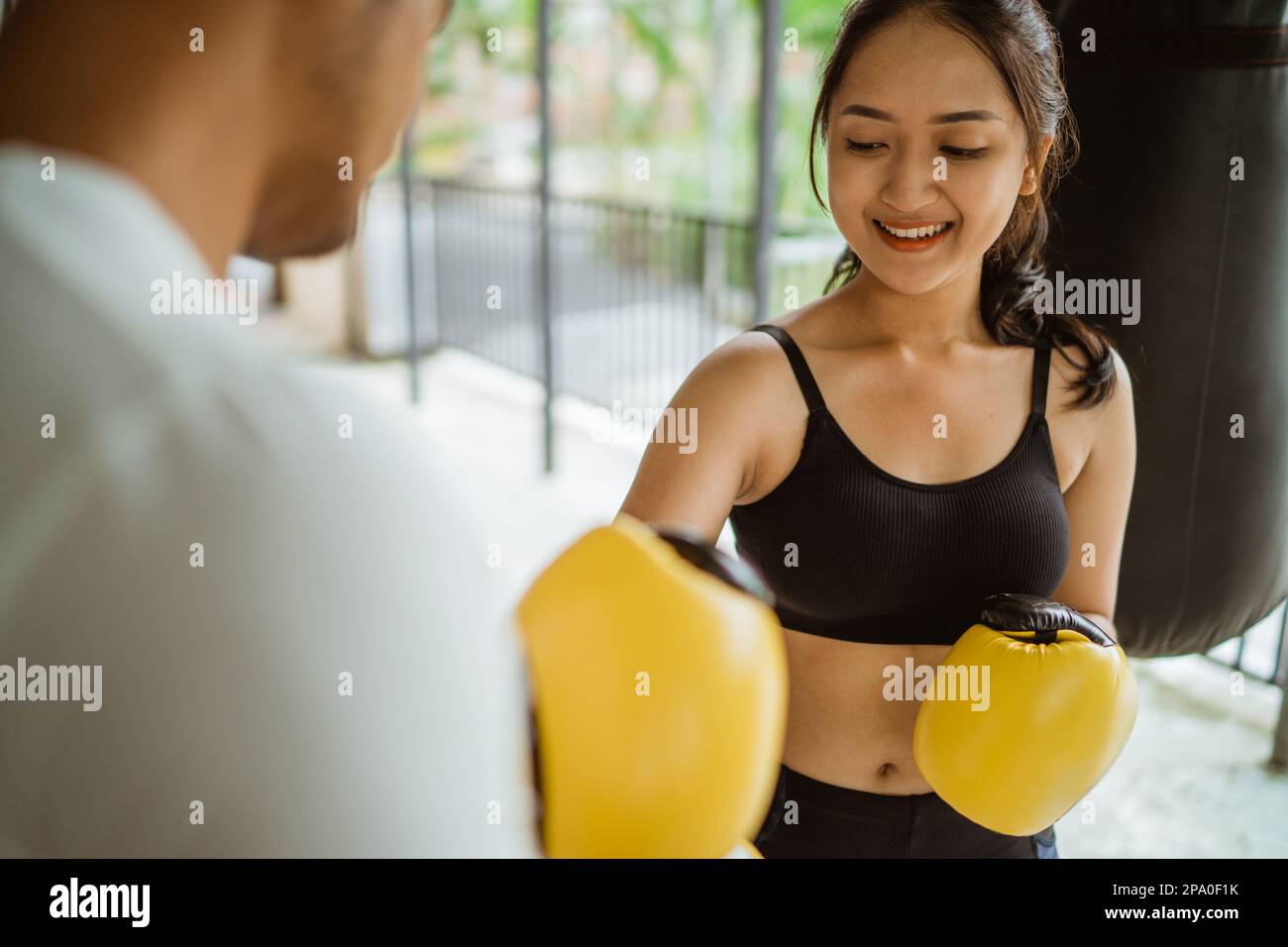 a boxer helped by the boxing coach to wearing the boxing gloves Stock Photo