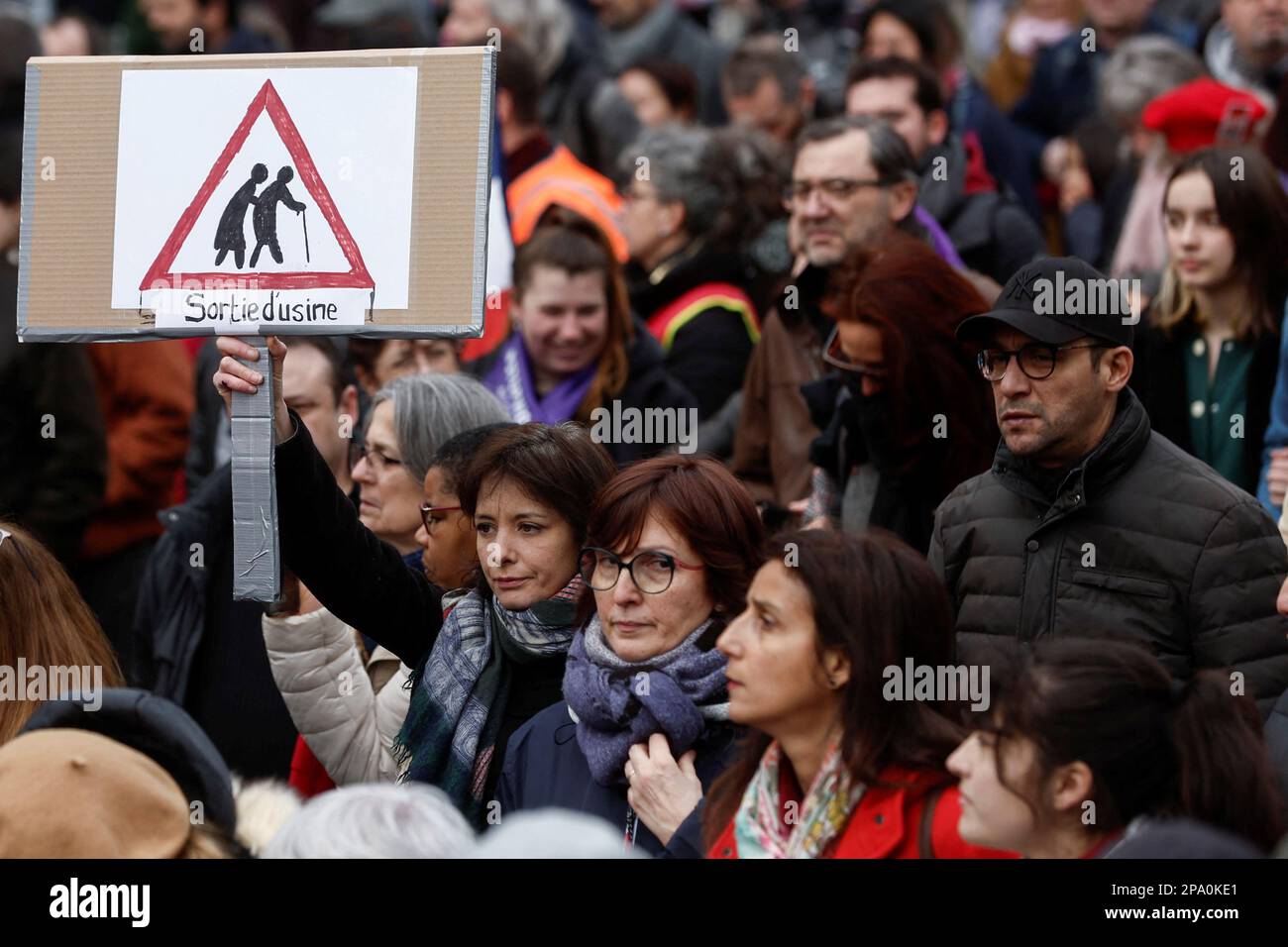 A woman holds a placard at a demonstration against the government's pension reform plan in Paris, France, March 11, 2023. REUTERS/Benoit Tessier Stock Photo