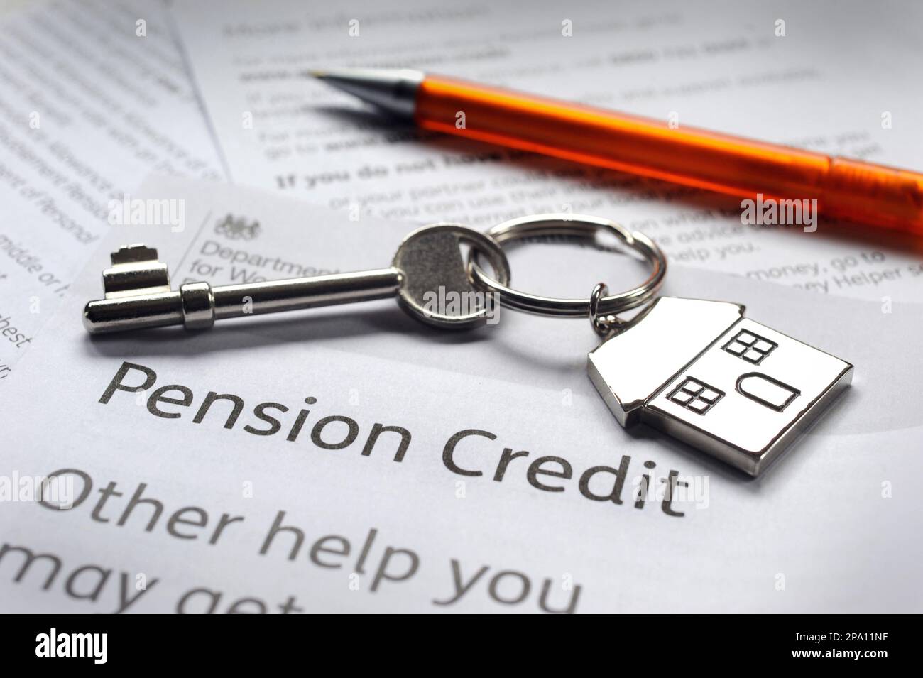 GOVERNMENT PENSION CREDIT INFORMATION LEAFLET WITH PEN AND HOUSE KEY RE STATE PENSIONS BENEFITS INCOMES PENSIONERS ETC UK Stock Photo