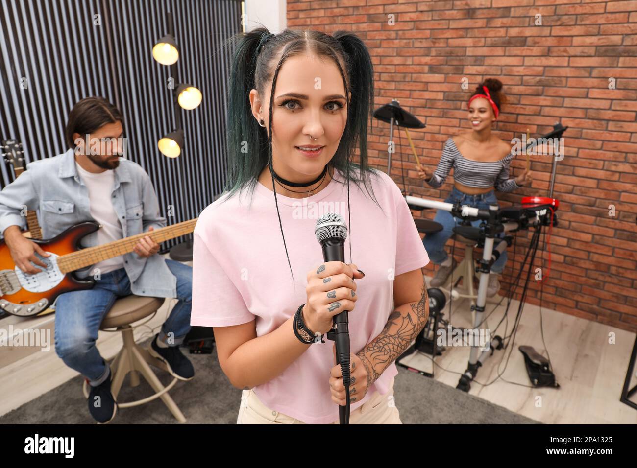 Music band performing in modern recording studio Stock Photo - Alamy