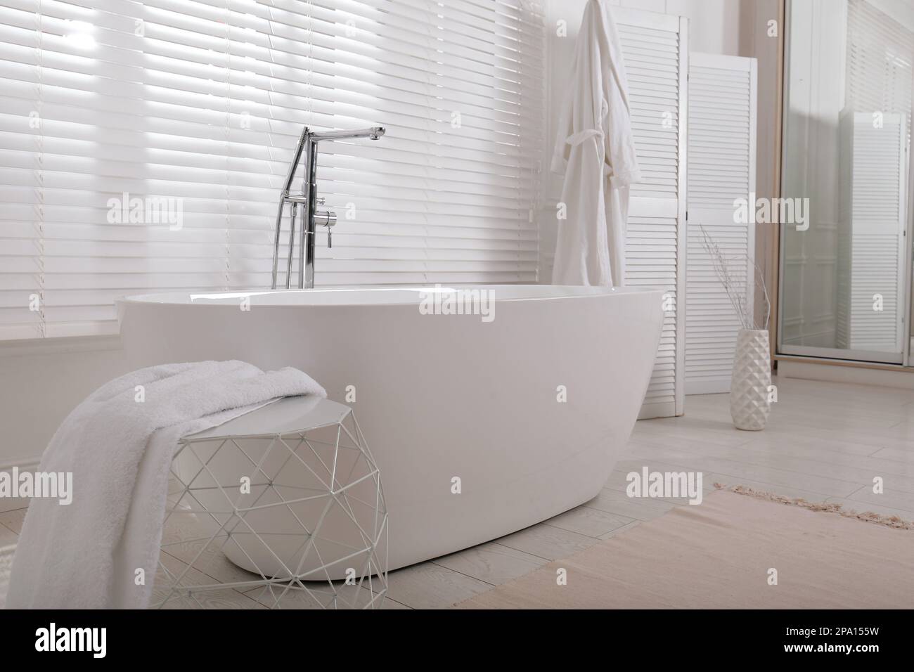 Minimal bathroom interior with modern white tub Stock Photo - Alamy
