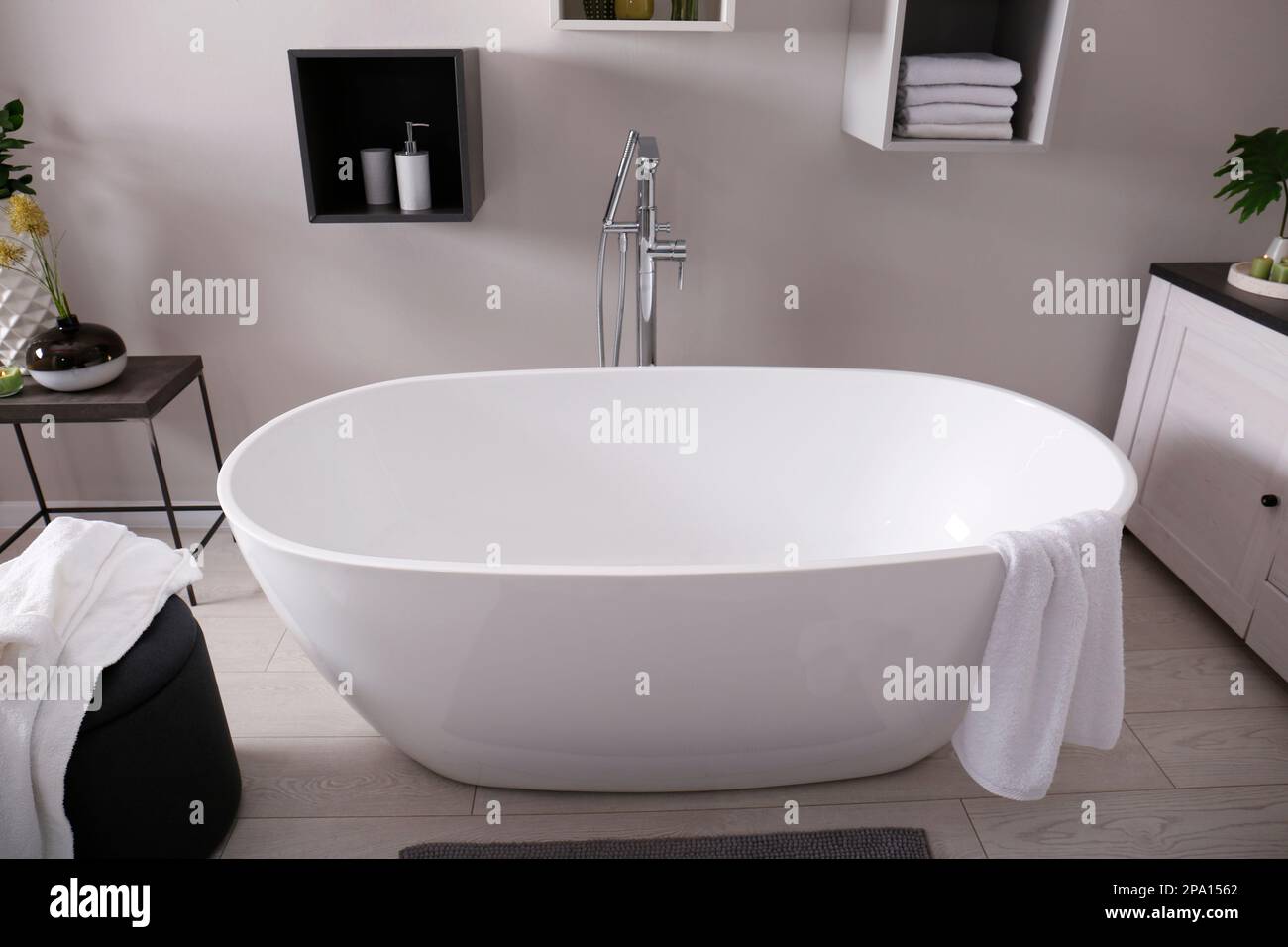 Stylish bathroom interior with modern white tub Stock Photo - Alamy