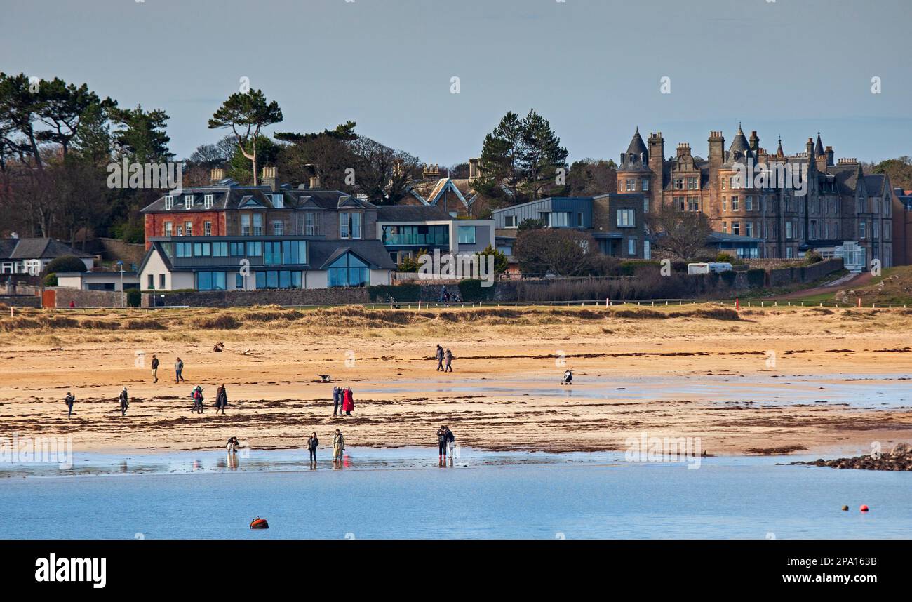 North Berwick, East Lothian, Scotland, UK. 11th march 2023. Sunshine blessed the seaside for those out and about on the beach and the water with a coll temperature of 4 degrees centigrade. Pictured: People enjoying a stroll on West Bay beach. Credit: Archwhite/alamy live news. Stock Photo