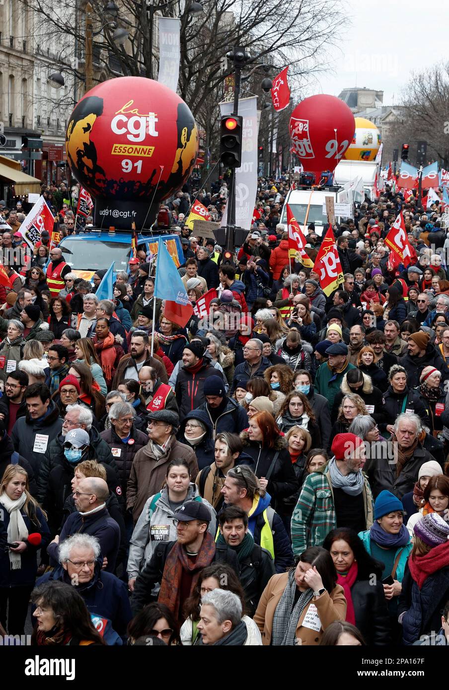 General Confederation of Labour (CGT) trade union signs are seen as demonstrators march against the government's pension reform plan in Paris, France, March 11, 2023. REUTERS/Benoit Tessier Stock Photo