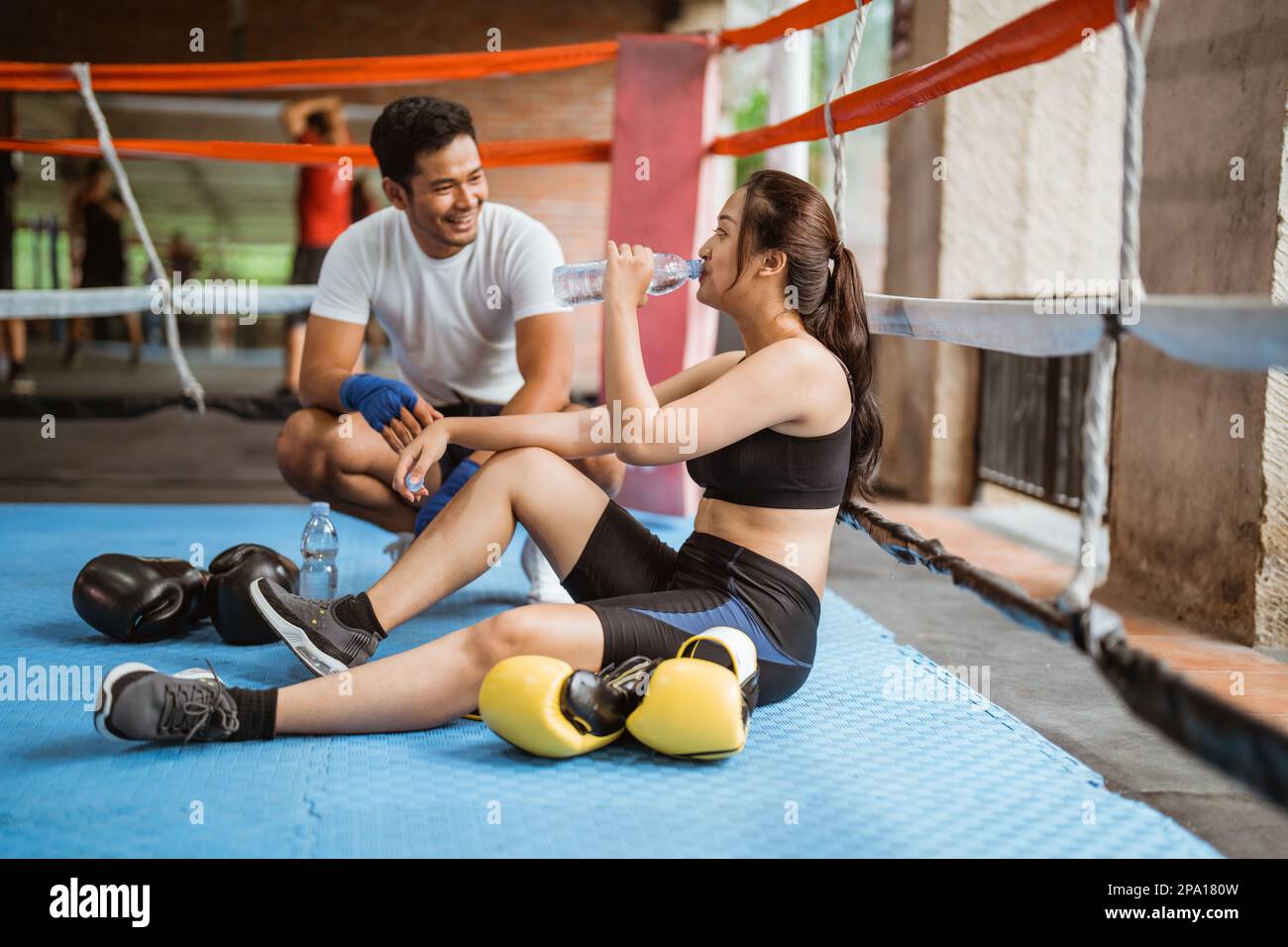 the male boxer talking to the female boxer Stock Photo