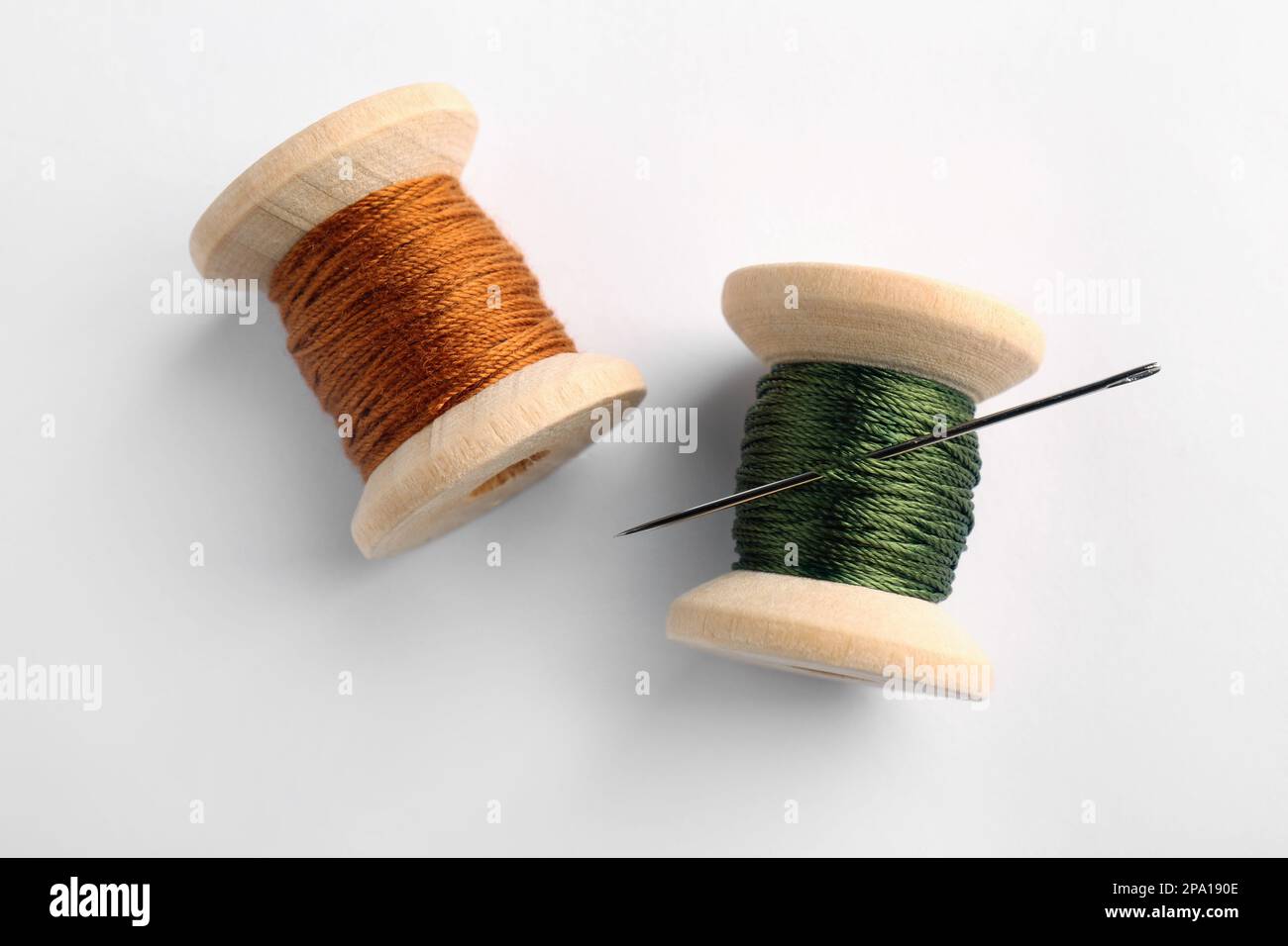 Thread Top View Colorful sewing threads with needle on white background, top view Stock ...