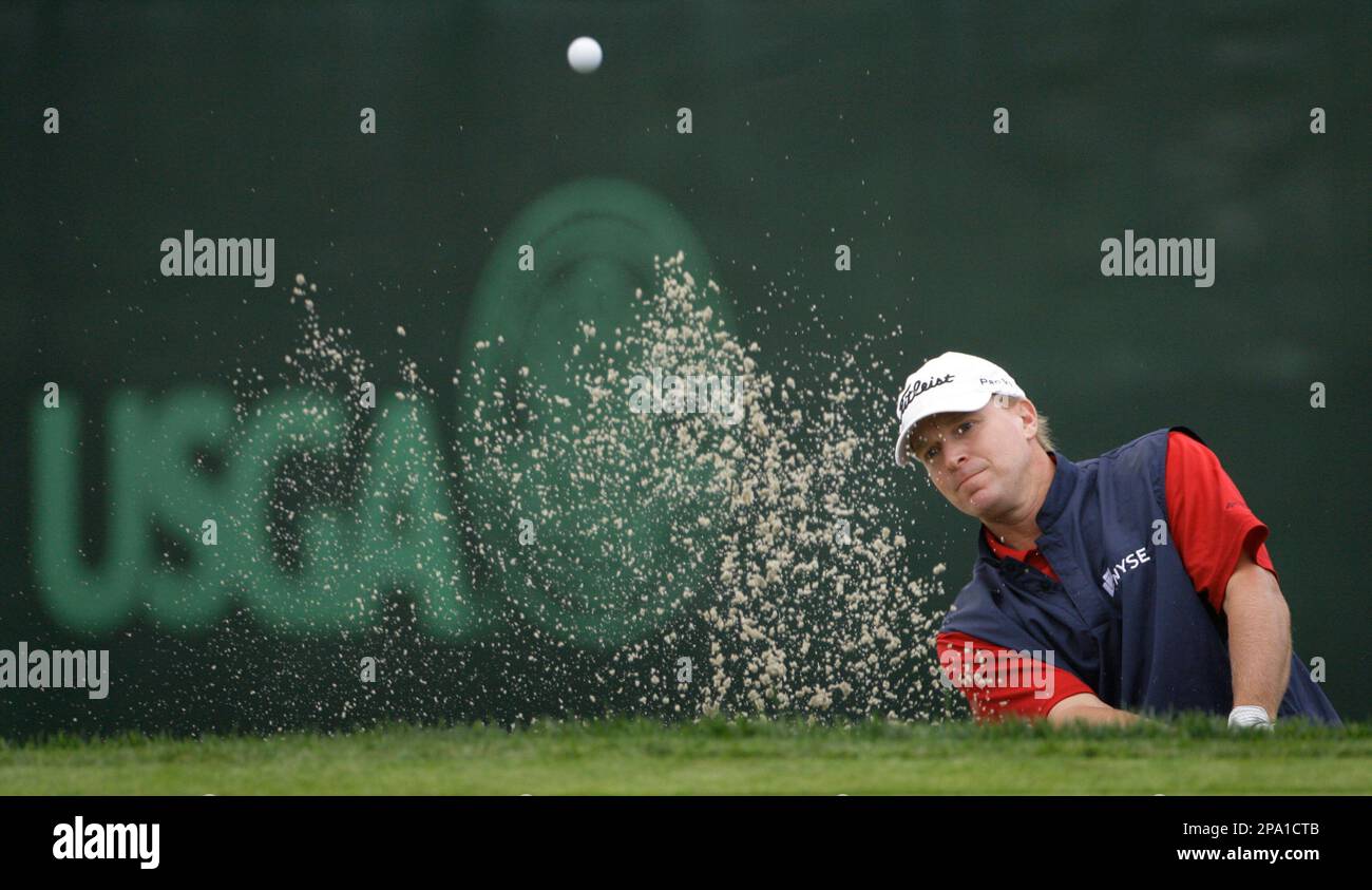 Steve Stricker hits out of a bunker on the 12th green during the