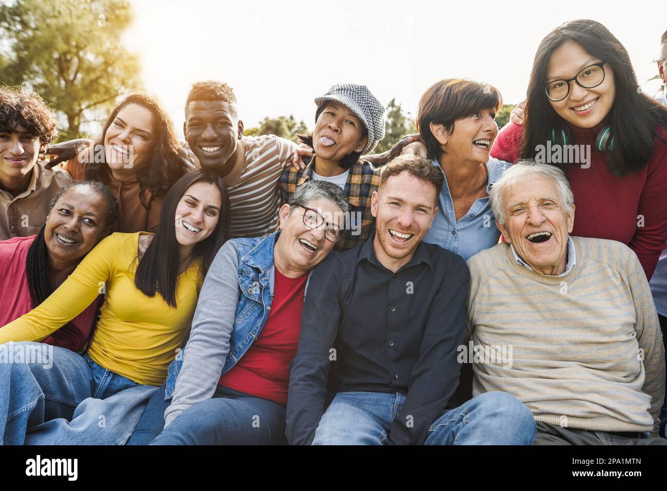 Group Of Multigenerational People Smiling In Front Of Camera 