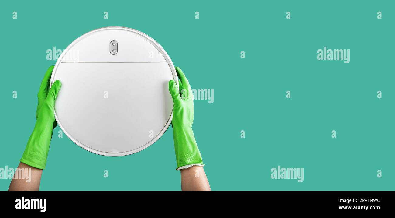 Robot vacuum cleaner in cleaners hands on ad banner, background with
