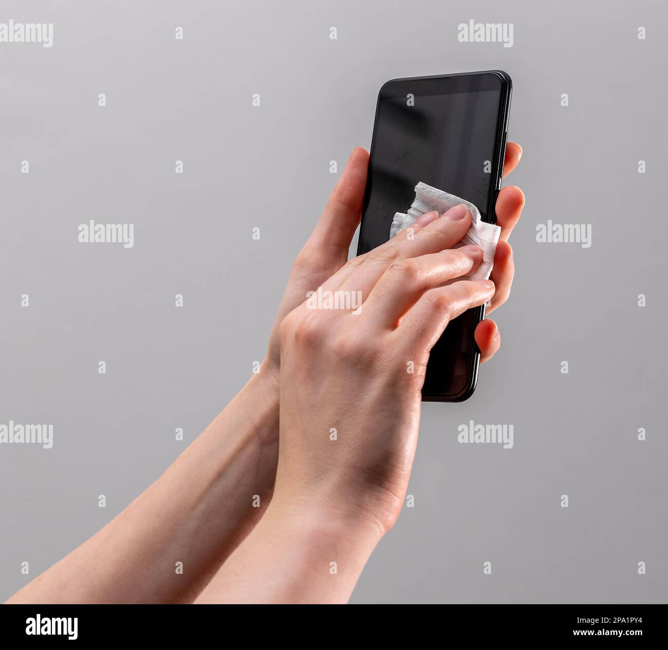 Hand wiping, cleaning phone screen with wet wiper. Gadget, mobile