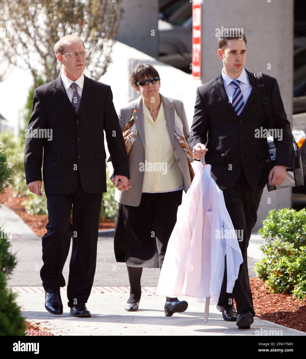 Cliff Entwistle, left, and his wife Yvonne, center, arrive with their