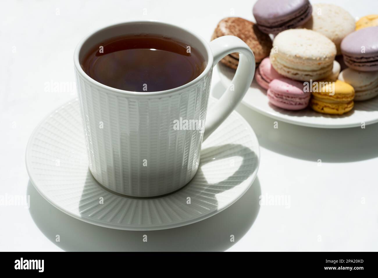 Tea time. Cup of tea with a teapot and macaroon. Stock Photo