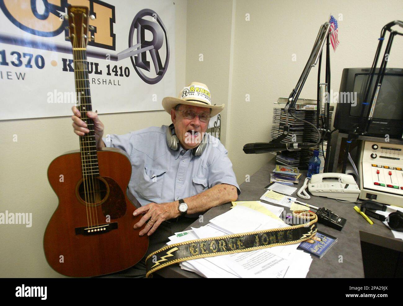 Veteran broadcaster Tom Perryman poses with a guitar stolen from country  star George Jones, Wednesday, June 4, 2008, in Tyler, Texas. The guitar was  purchased by Larry Berry of Chandler, Texas, for