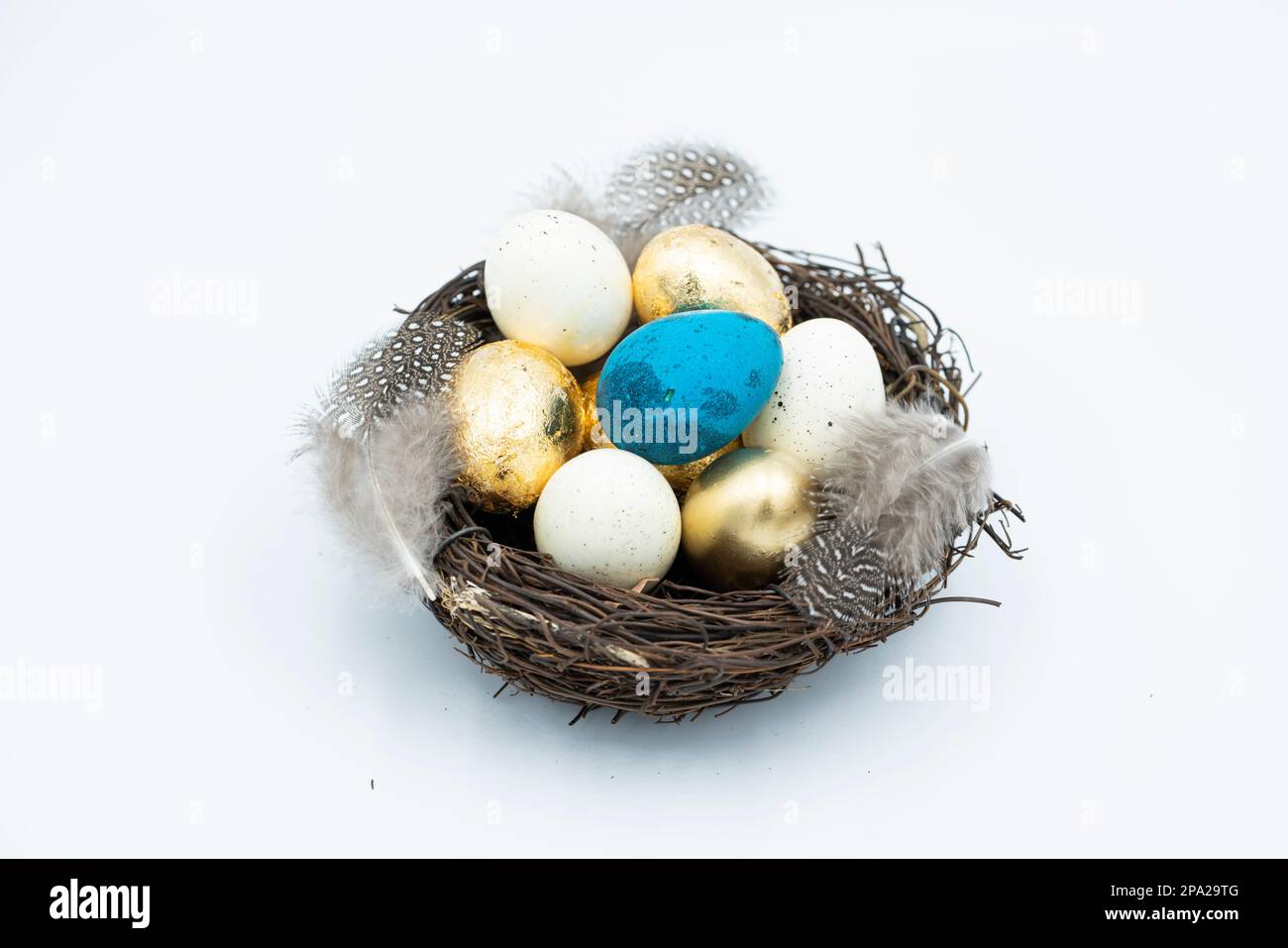 Easter golden and black eggs, feather. Stock Photo