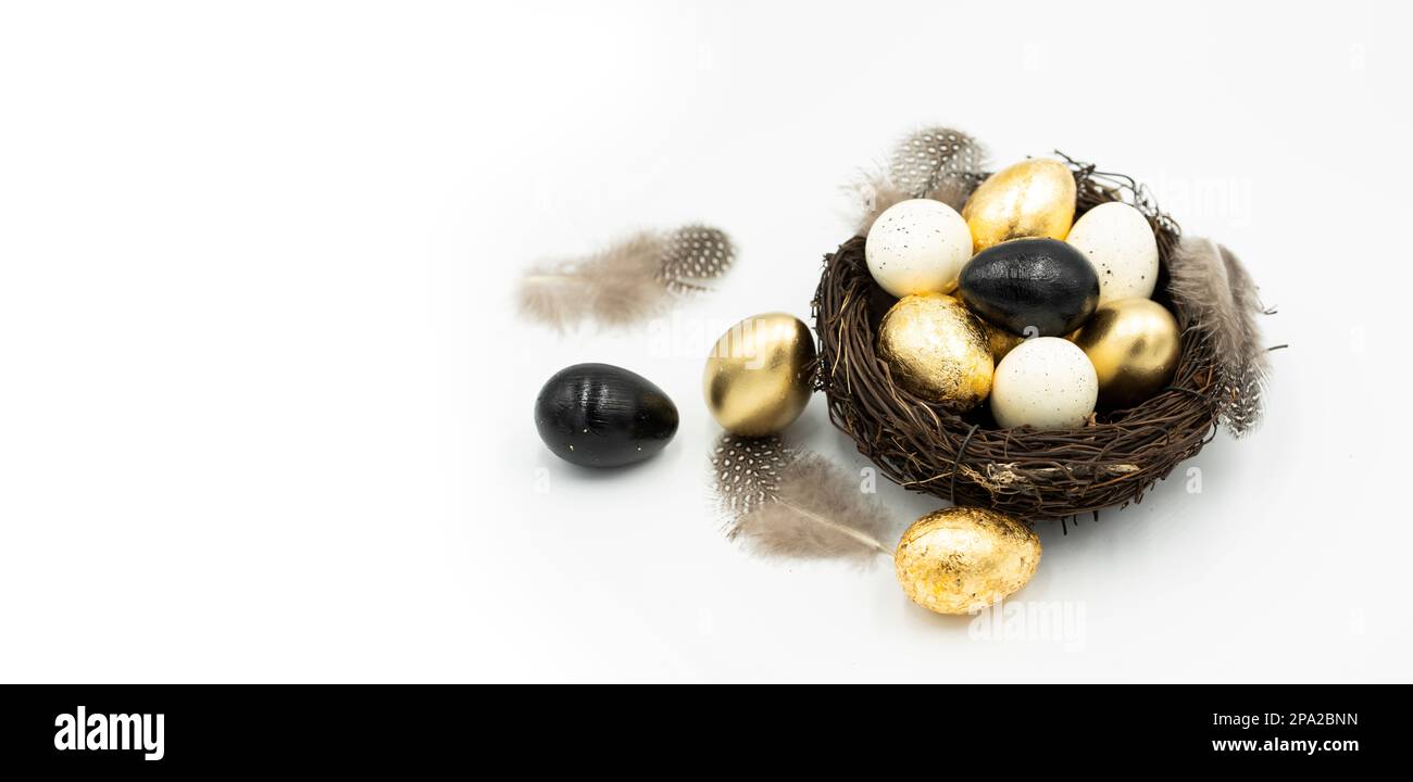 Easter golden and black eggs, feather. Stock Photo