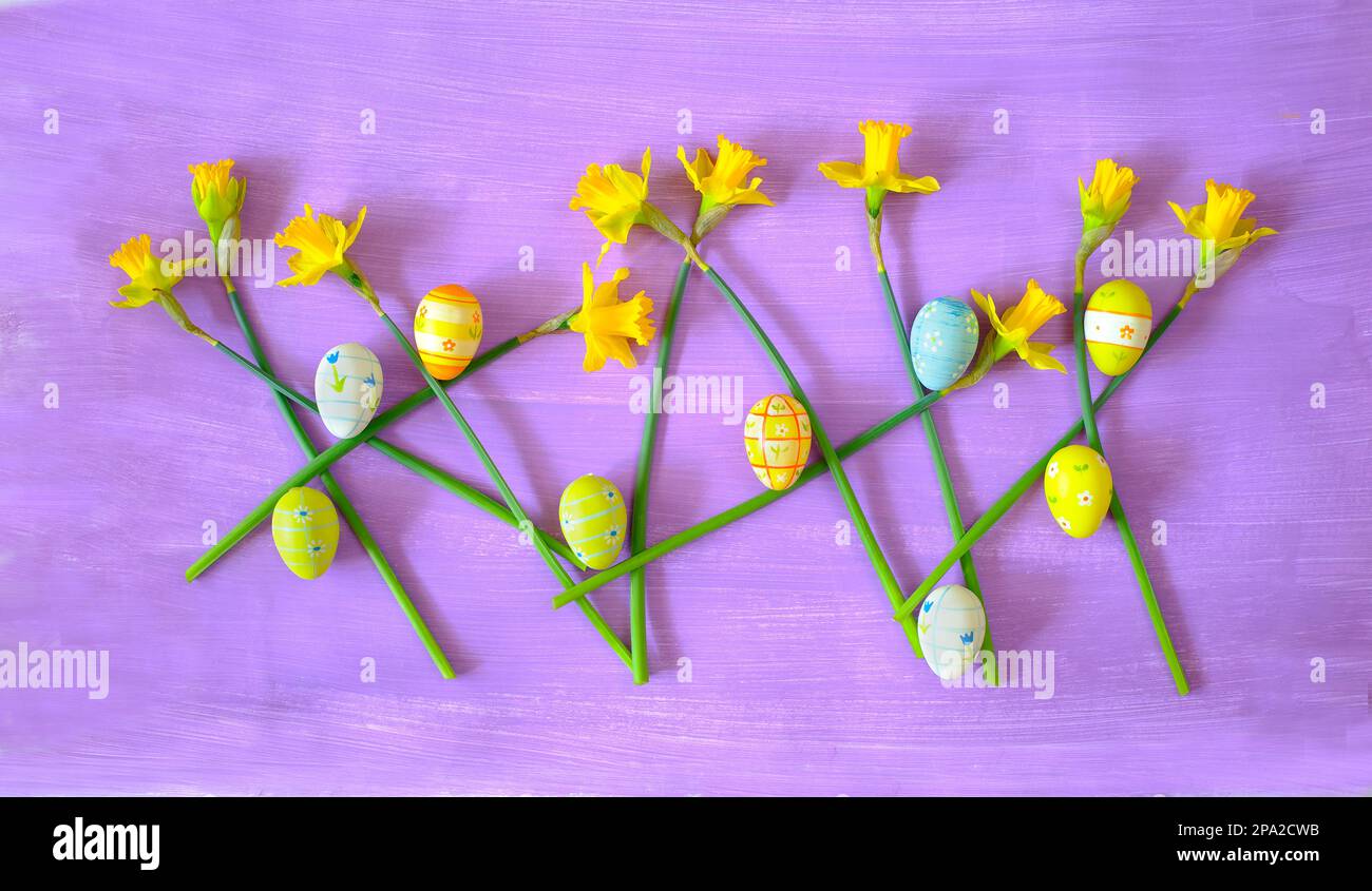 easter decoration with handpainted easter eggs and daffodil flowers,flat lay Stock Photo